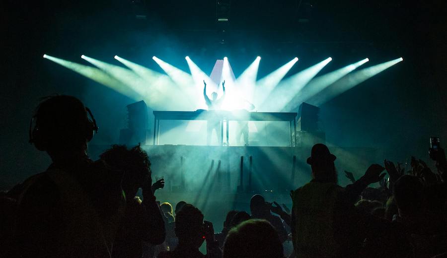 People on stage illuminated by concert lights.