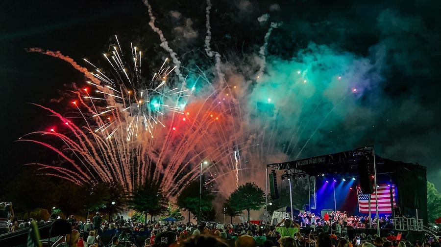 Fireworks show with an event stage in the background.