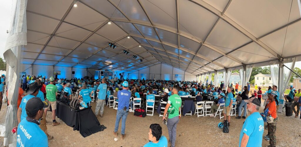 Wide view of everyone at the 40th Carter Work Project in matching blue shirts